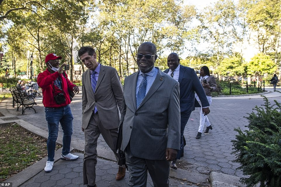 Attorney Deveraux Cannick (center), representing R&B star R. Kelly, arrives at Brooklyn Federal Court House on Monday, Sept. 27, 2021, as the jury resumed deliberations in Kelly's trial