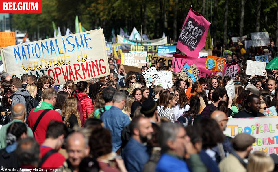 Thousands of environmentalist gather during a demonstration to draw attention to global warming and climate change in Brussels, Belgium