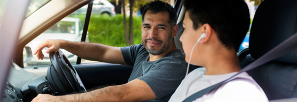 father driving son