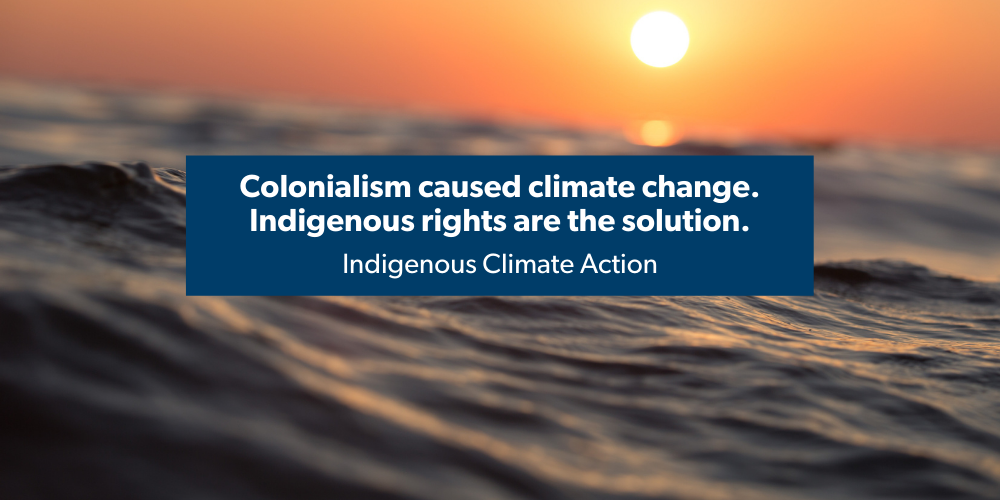 Water with shining sun in distance with text: "Colonialism caused climate change. Indigenous rights are the solution."