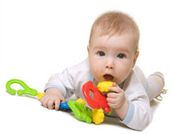 baby on floor with toy