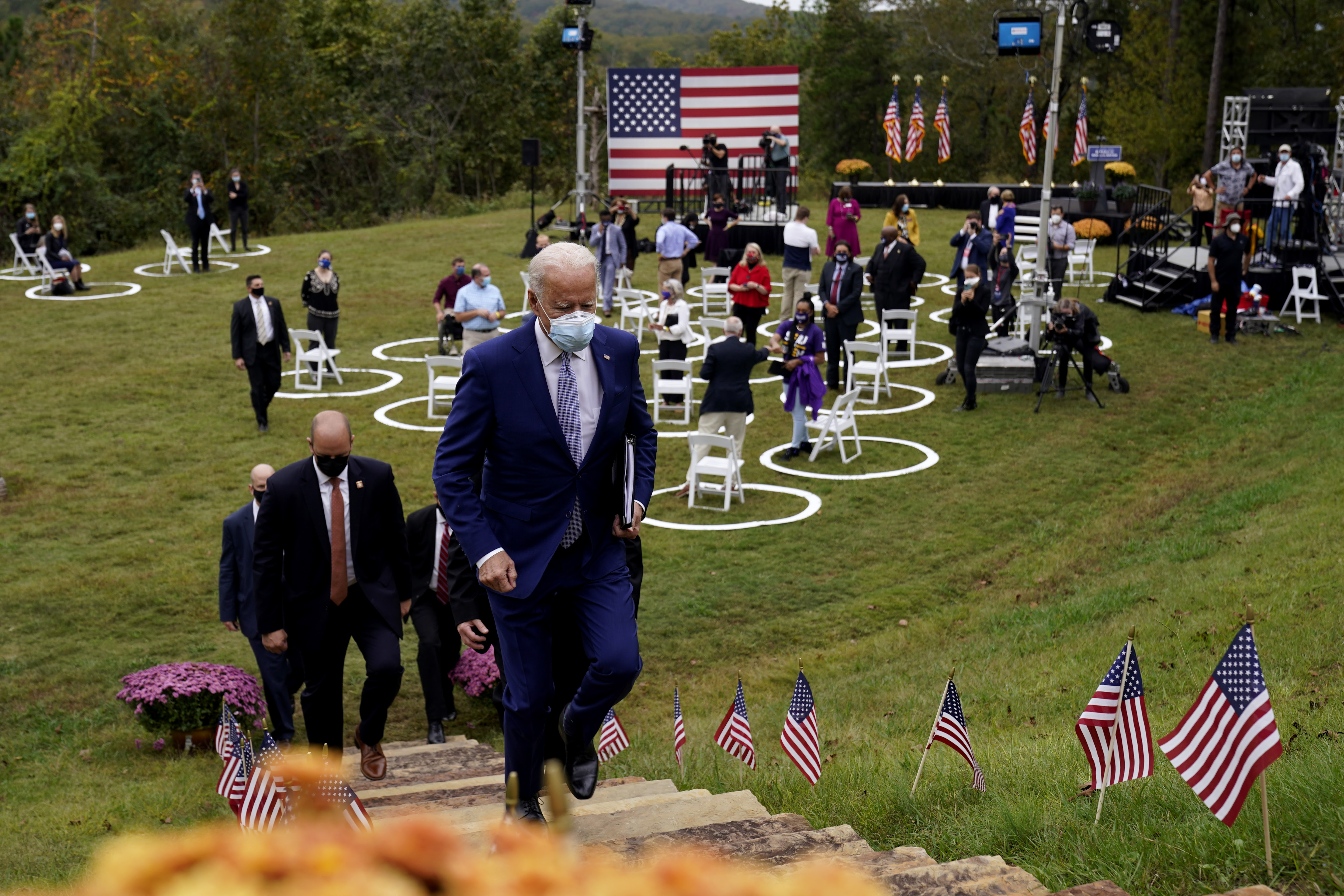 This image shows Joe Biden leaving an outdoor venue