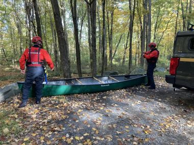 two Rangers prepare canoed in the woods to rescue air boat