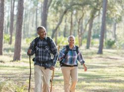 Photo of an elderly couple walking on a nature trail