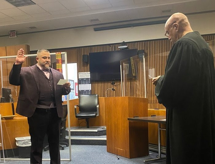 A lawyer being sworn in by a judge