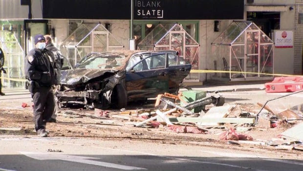 Van hits car, smashing outdoor dining structure in New York City