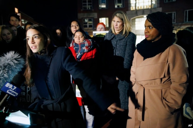 Rep.-elect Alexandria Ocasio-Cortez, D-N.Y.,, left, speaks at a small rally outside an orientation meeting for incoming members of Congress at Harvard University as Rep.-elect Ayanna Pressley, D-Mass., right, and Rep.-elect Lori Trahan, D-Mass. (AP Photo)