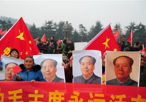 Chinese protestors touting pictures of Mao Zedong / AP