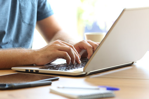 A person typing on a laptop.