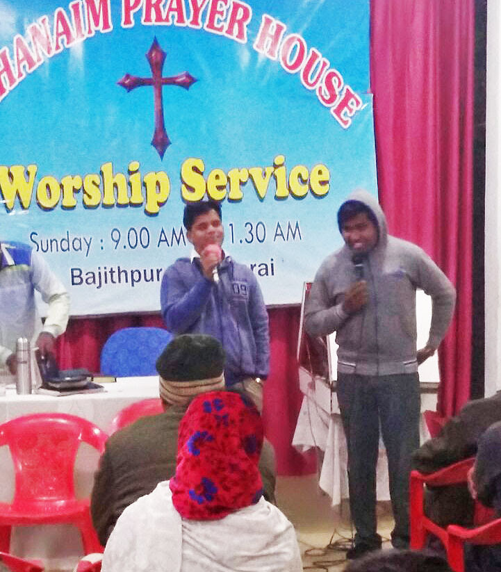  Pastor Ajay Kumar (in blue) and a student from Bethany Bible College, in Kerala state, at a prayer service. (Morning Star News)