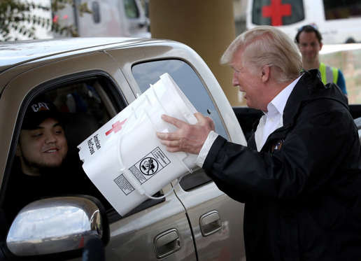 Slide 3 of 12: PEARLAND, TX - SEPTEMBER 02:  U.S. President Donald Trump hands out emergency supplies to residents impacted by Hurricane Harvey while visiting the First Church of Pearland September 2, 2017 in Pearland, Texas. Pearland, just south of Houston, was heavily damaged by the floodwaters created by the hurricane.   (Photo by Win McNamee/Getty Images)