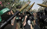 Hamas terrorists hold missiles they use to persuade themselves that they are forcing Israel into a ceasefire.