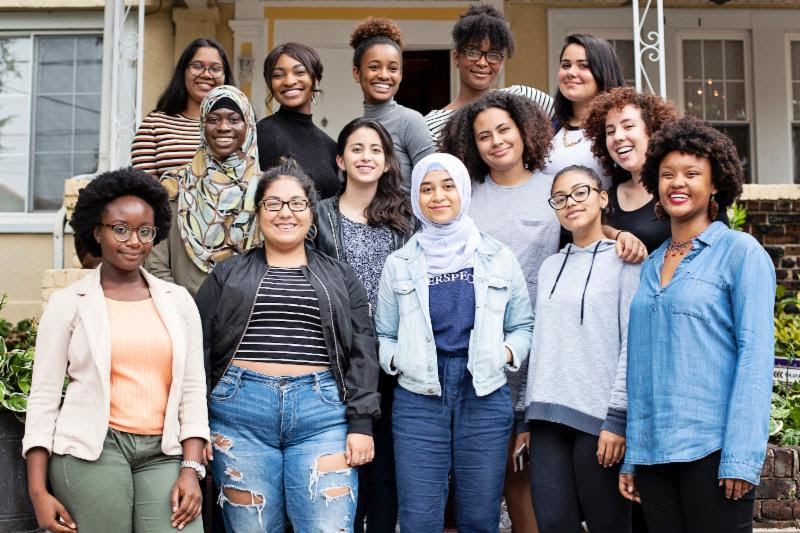 Diverse group of young women smiling and facing the camera