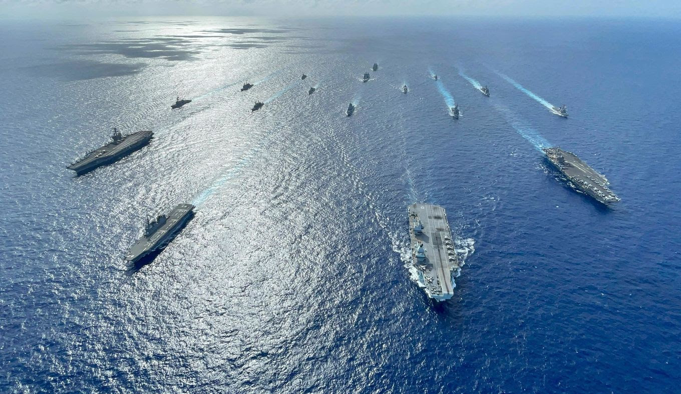 The U.K, Japan and U.S. carrier strike groups sail to conduct multiple operations in the Philippine Sea in October 2021. (Gray Gibson/U.S. Indo-Pacific Command/AP)
