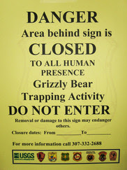 yellow warning sign for bear trapping