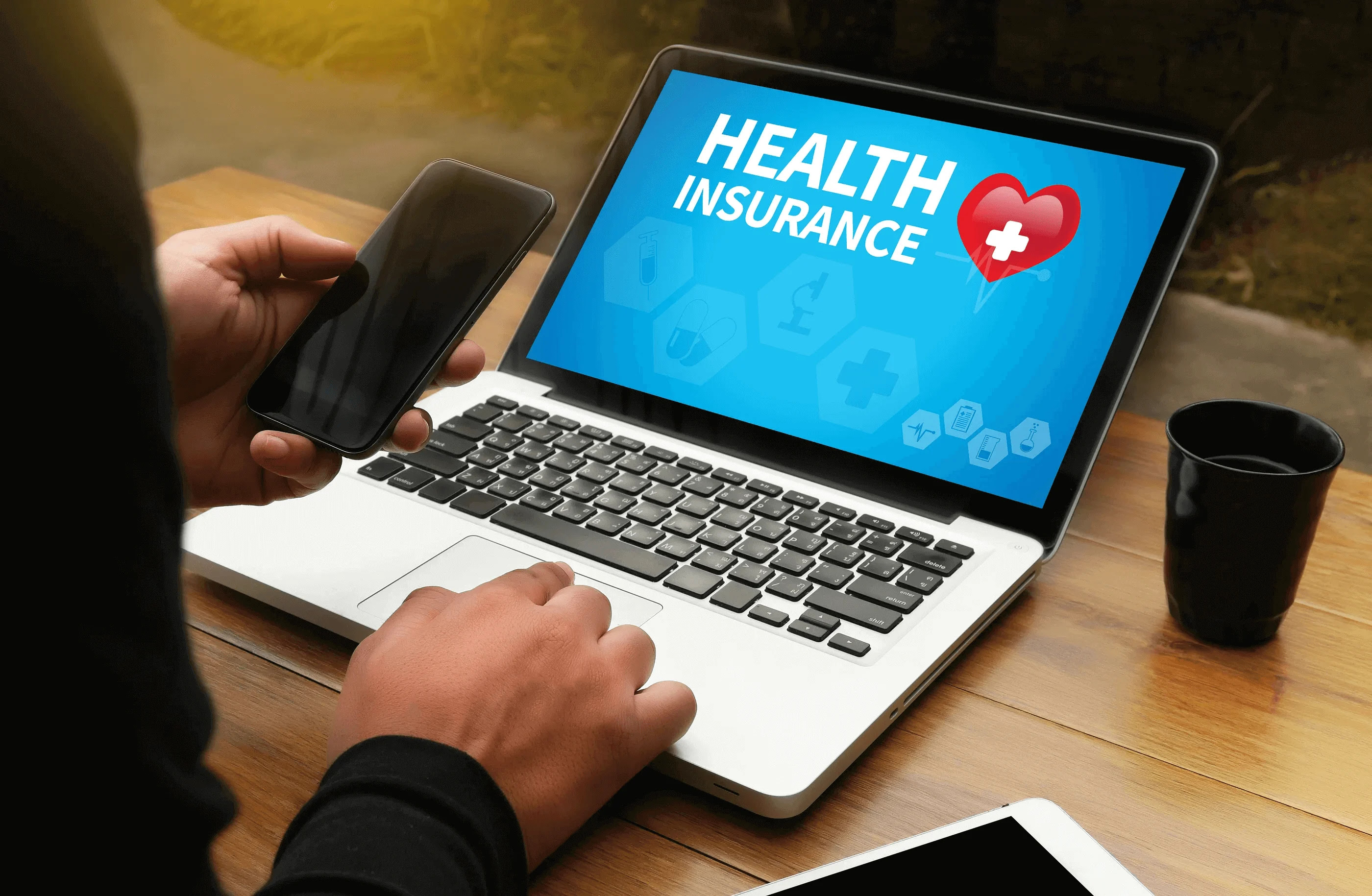 A laptop screen that reads, “health insurance.”