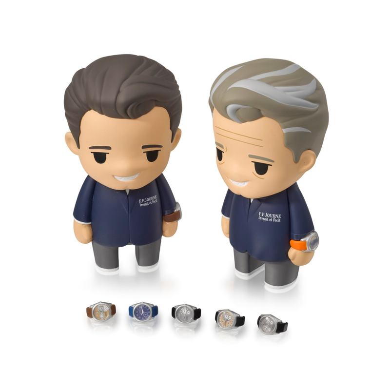 Two small figurines wear F.P.Journe shirts with small watches on their wrists against a white background.