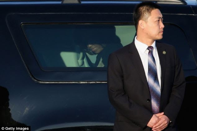 Blending in: The Secret Service detail guarding Mrs. Obama and her family members includes Asian-American agents like this man