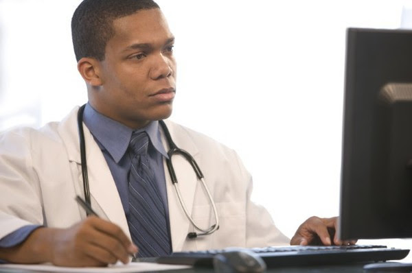Male doctor at computer