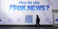 A person walks past the Fox News headquarters in New York City