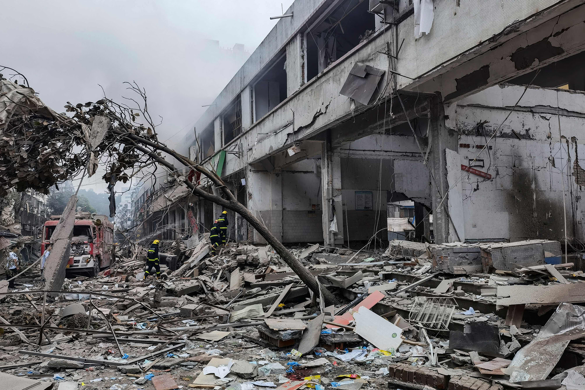 A heavily damaged building and piles of debris in the street are seen after a gas explosion in China 