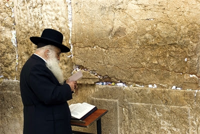 An ultra-Orthodox Jewish man
                  prays at the Western Wall.