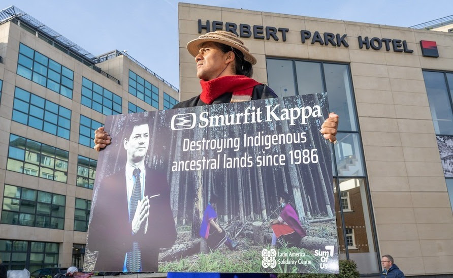 Misak leader Pedro Josse Velasco Tumina holding a sign at a protest outside Smurfit Kappa's annual shareholder meeting in Dublin