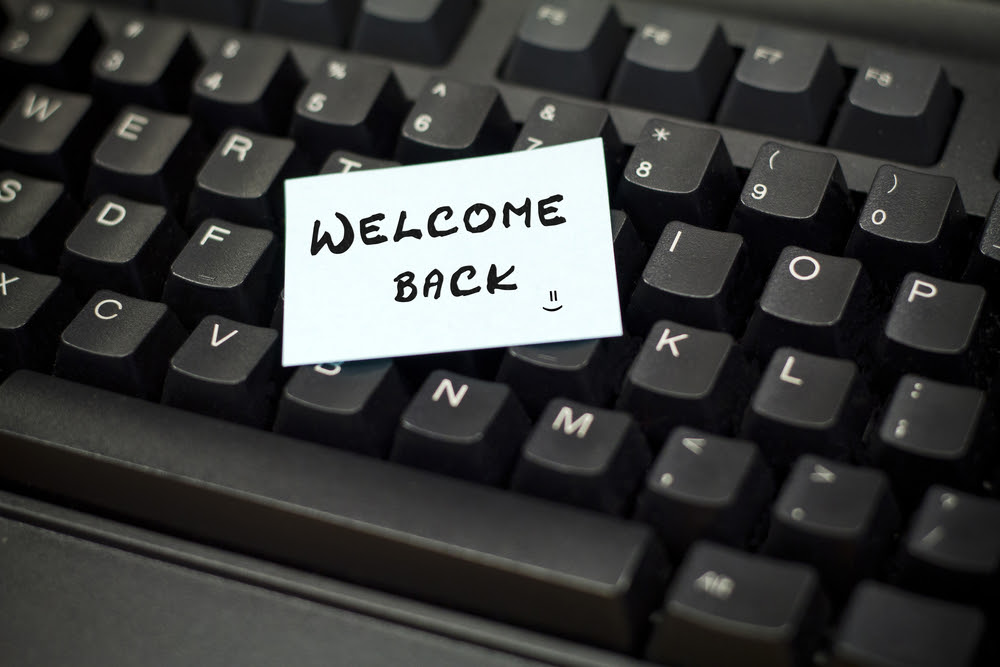 computer keyboard with welcome back note