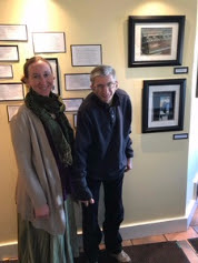 Alexandra Turner stands with a student in front of his artwork on display at Penny Cluse in Burlington.