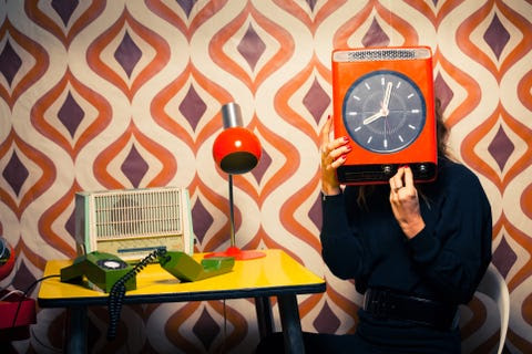 Secretary in Vintage Office holding a Clock