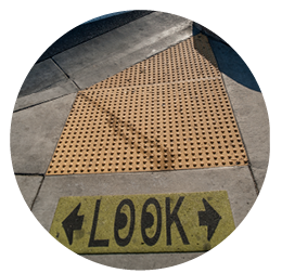 An ADA sidewalk mat with a walk mat that says "Look" below it.