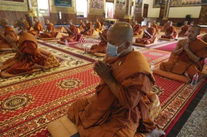 Monks observe social distancing while chanting in a pagoda in Phnom Penh. From thestar.com