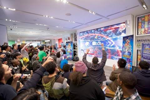In this photo provided by Nintendo of America, fans gather at Nintendo NY to watch the Pokkén Tourna ...