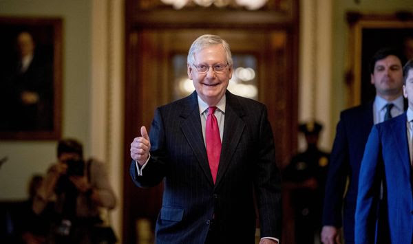 Senate Majority Leader Mitch McConnell of Ky. gives a thumbs up as he leaves the Senate chamber on Capitol Hill in Washington, Wednesday, March 25, 2020, where a deal has been reached on a coronavirus bill. The 2 trillion dollar stimulus bill is expected to be voted on in the Senate Wednesday. (AP Photo/Andrew Harnik)