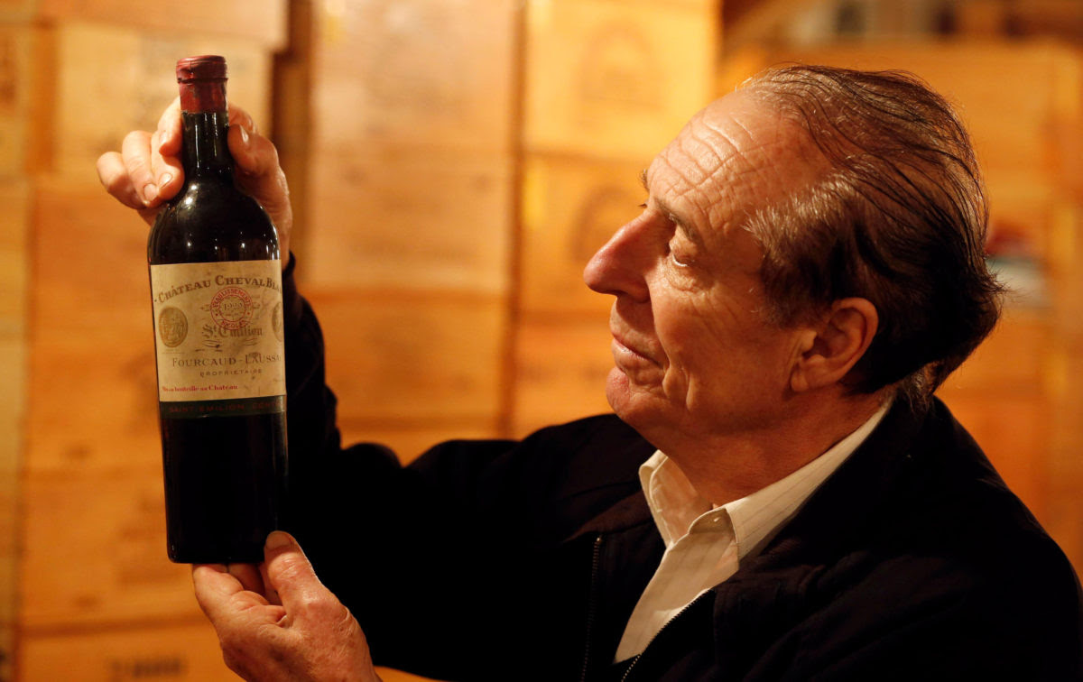 French collector Michel-Jack Chasseuil shows off a Chateau Cheval Blanc 1929 as he presents his collection of rare and prestigious vintages which is one of the greatest in the world in his wine cellar in La Chapelle-Baton, France, March 14, 2017. Michel-Jack Chasseuil has amassed more than 40,000 bottles over his lifetime. Picture taken March 14, 2017. REUTERS/Regis Duvignau - RC12D4C20810