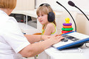 A child getting a hearing screening test. 