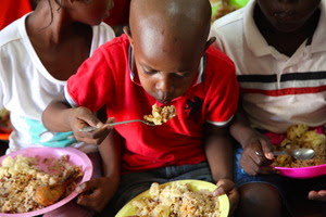 boy blowing on rice 2 boy blowing on rice 2