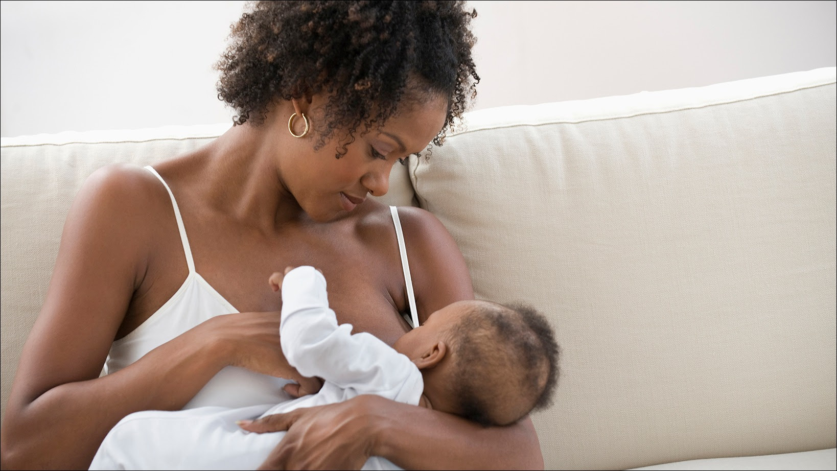 The figure shows an African American mother breastfeeding her baby.