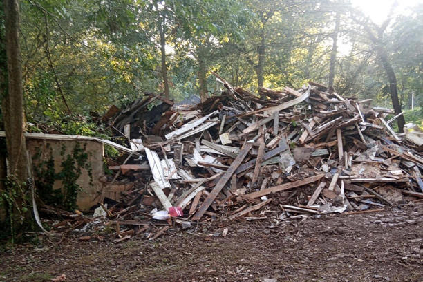 In this photo provided by Susan Hodgson, her mistakenly demolished family home sits in a pile of lumber and debris in southwest Atlanta, Georgia, on Sept. 15, 2023.
