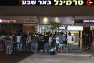 Israelis standing outside the scene of shooting and stabbing attack at the Central Bus Station in the southern city of Be'er Sheba.