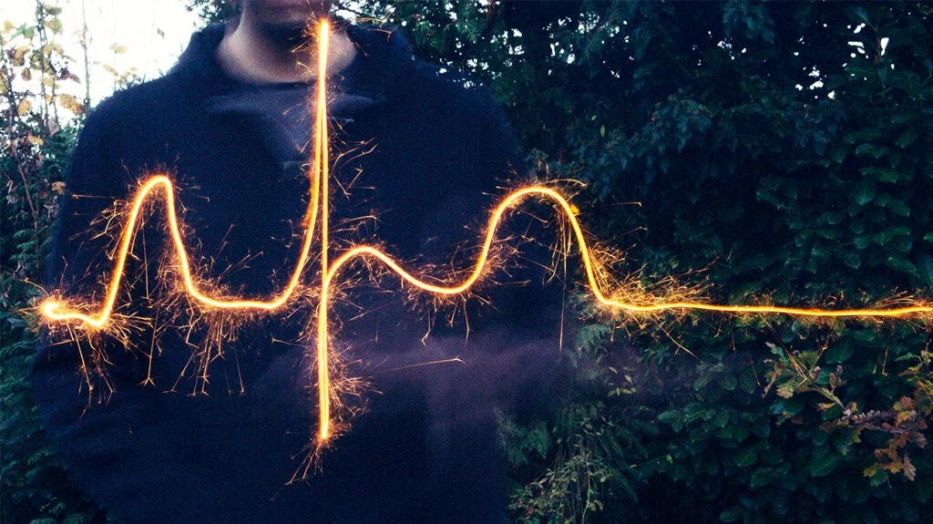 Someone making an ECG trace using a sparkler