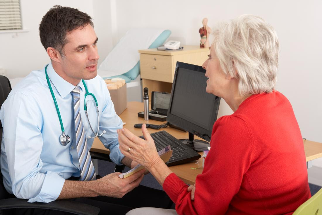 senior woman speaking to male doctor