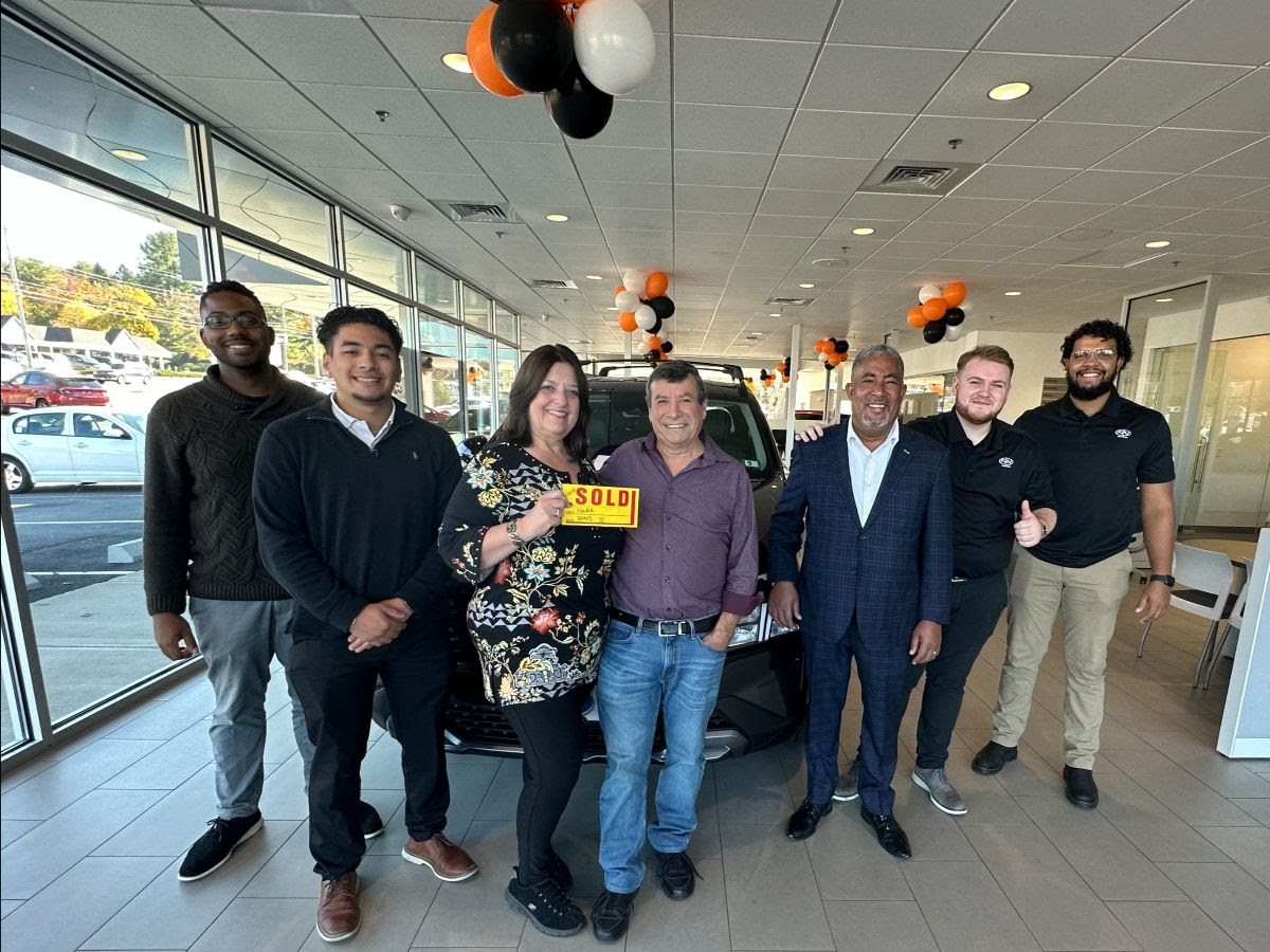 Sandi and her husband with the incredible staff of Key Auto Hyundai of Salem, NH.