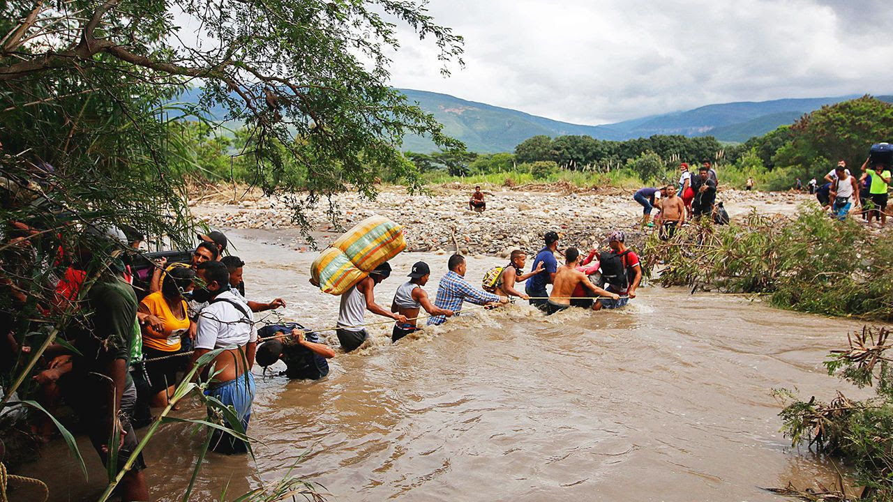 Migrants use a rope to cross the Tachira river, the natural border between Colombia and Venezuela.