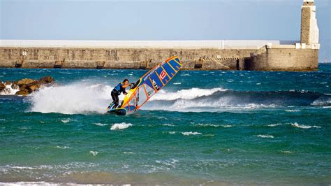 Image showing vibrant kitesurfers gracefully gliding across the water in Tarifa