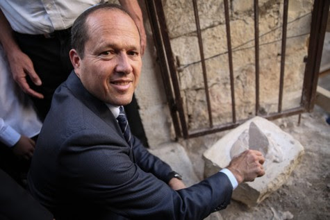 Jerusalem Mayor Nir Barkat puts cement on the official cornerstone celebrating the reopening of the Tiferet Israel Synagogue in Jerusalem's Old City.