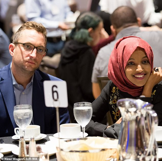 Ilhan Omar has been getting up close and personal with married aide Tim Mynett, DailyMail.com can reveal. The Minnesota congresswoman has been carrying on with Mynett, 38, a campaign fundraising expert, for several months, according to a source. Pictured: Omar and Mynett in Seattle on May 26 at a Council on American-Islamic Relations (CAIR) event