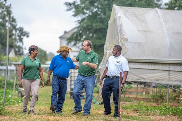 photo of producers discussing farming techniques