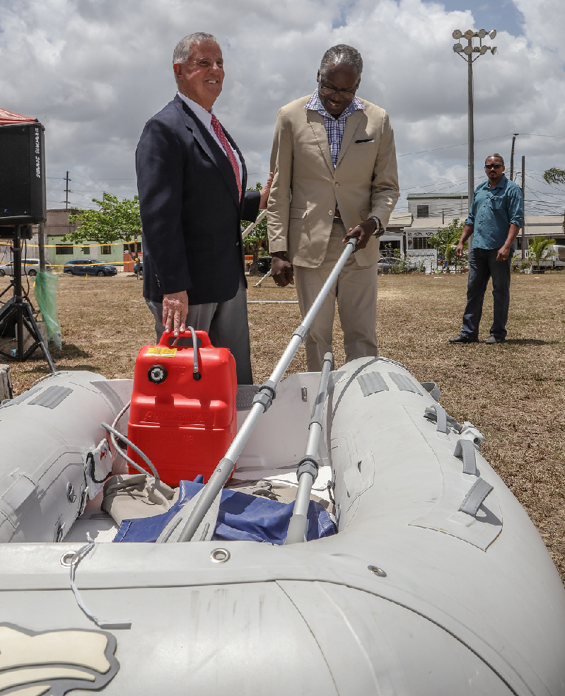 : Ambassdor Mondello and one of the four inflatable lifeboats the USA donated to Tunapuna/Piarco Corporation