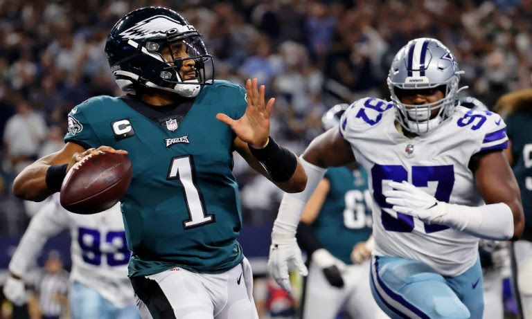 Jalen Hurts (#1) throws a pass for Eagles versus Cowboys